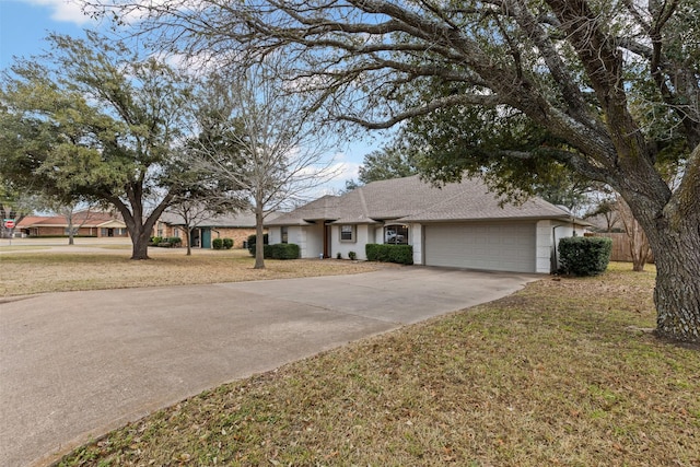 ranch-style home featuring a garage, a front yard, and driveway