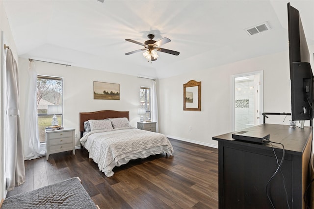 bedroom with dark wood-type flooring, multiple windows, baseboards, and visible vents