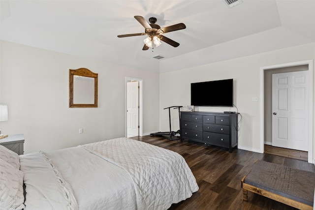 bedroom featuring ceiling fan, wood finished floors, visible vents, and baseboards