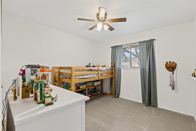 bedroom featuring baseboards, light colored carpet, and ceiling fan