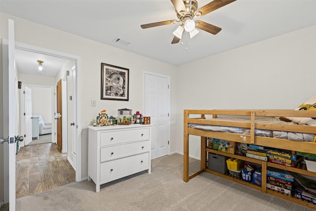 bedroom featuring visible vents, baseboards, and light colored carpet