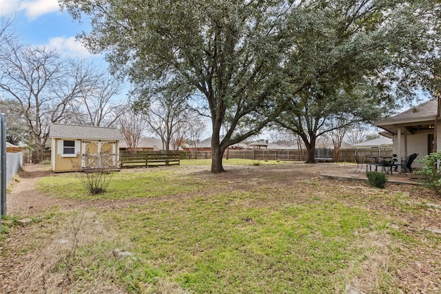 view of yard with a patio area, a shed, an outdoor structure, and a fenced backyard