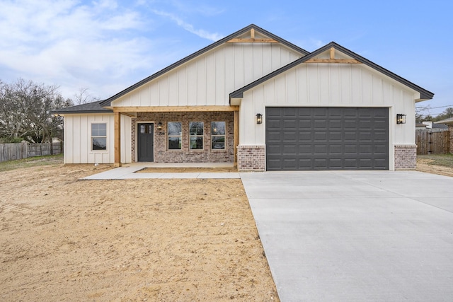 modern inspired farmhouse featuring concrete driveway, a garage, fence, and brick siding