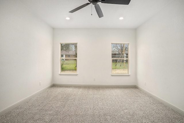 carpeted spare room with recessed lighting, baseboards, and a healthy amount of sunlight