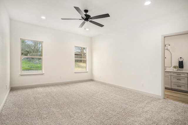 unfurnished bedroom featuring recessed lighting, light colored carpet, and baseboards