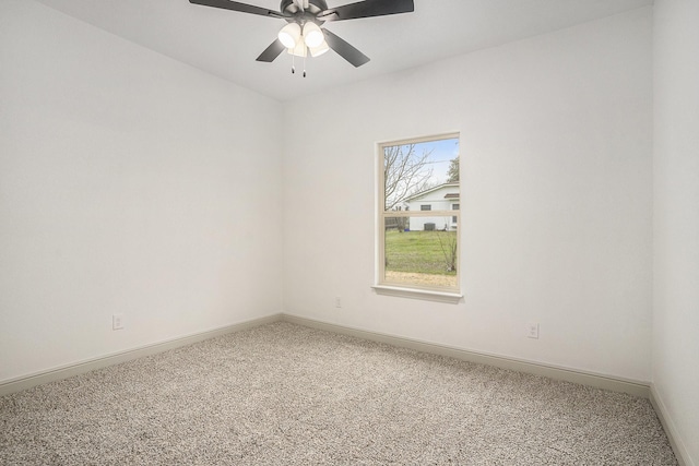 unfurnished room featuring carpet flooring, a ceiling fan, and baseboards