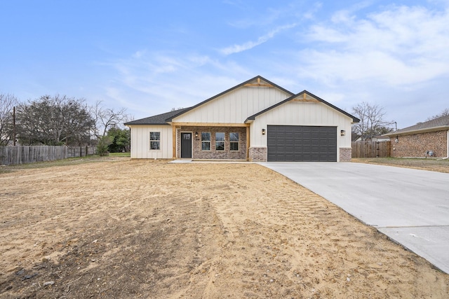 view of front facade featuring brick siding, concrete driveway, a garage, and fence