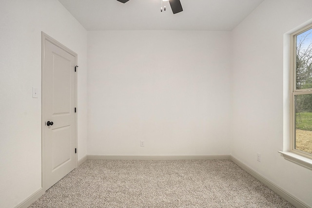 spare room with a ceiling fan, baseboards, and carpet floors