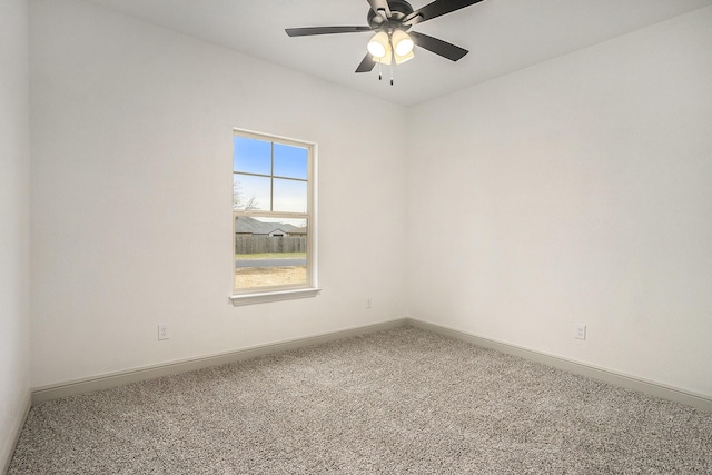 empty room featuring a ceiling fan, carpet, and baseboards