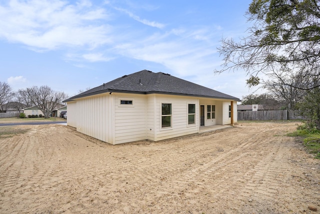 back of property featuring a patio and fence