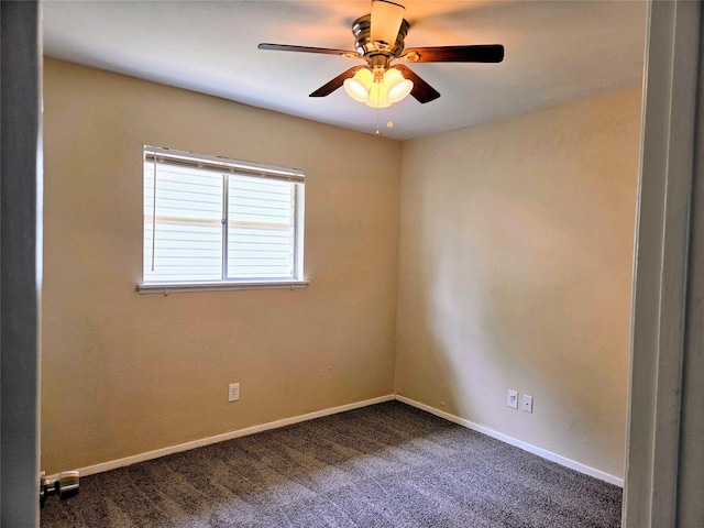 carpeted spare room featuring baseboards and ceiling fan