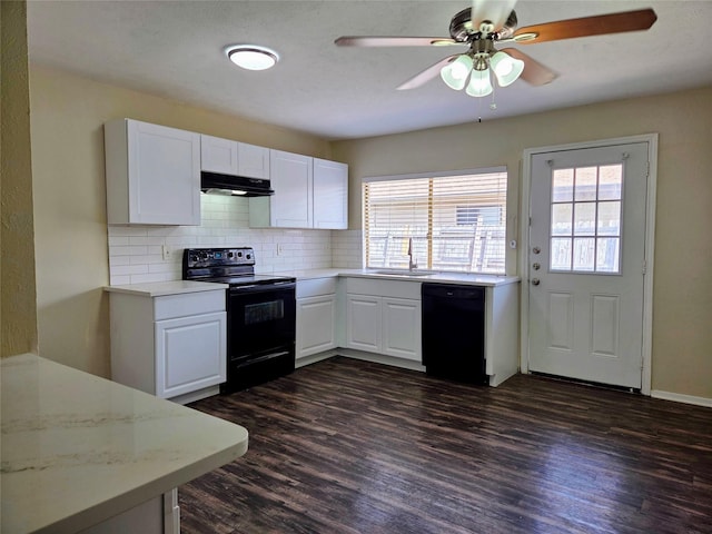 kitchen with black appliances, under cabinet range hood, a sink, backsplash, and dark wood-style floors