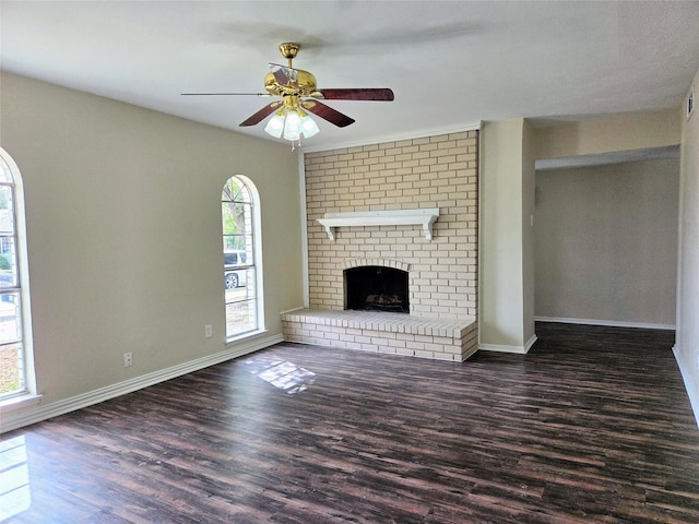 unfurnished living room featuring wood finished floors, a fireplace, baseboards, and ceiling fan