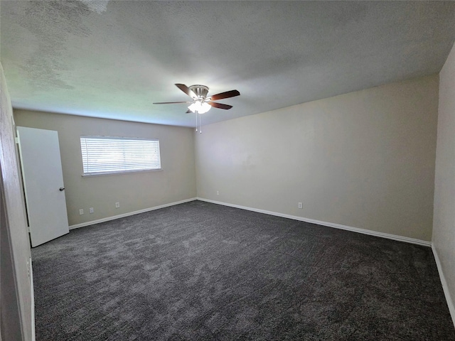 unfurnished room with dark carpet, a textured ceiling, baseboards, and ceiling fan