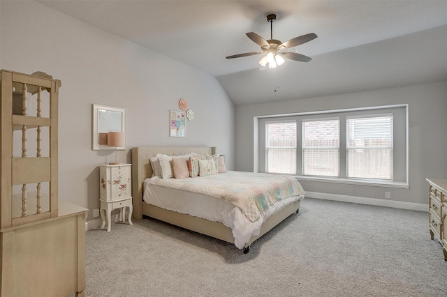 bedroom with light colored carpet, a ceiling fan, baseboards, and vaulted ceiling