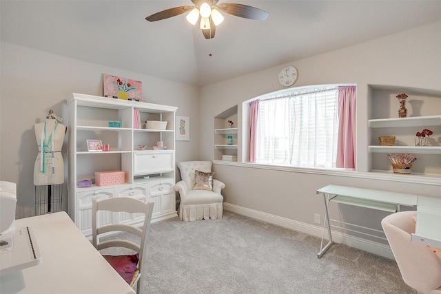 carpeted home office with built in features, a ceiling fan, baseboards, and vaulted ceiling