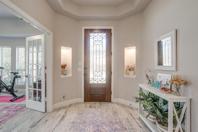 foyer featuring wood finished floors and baseboards