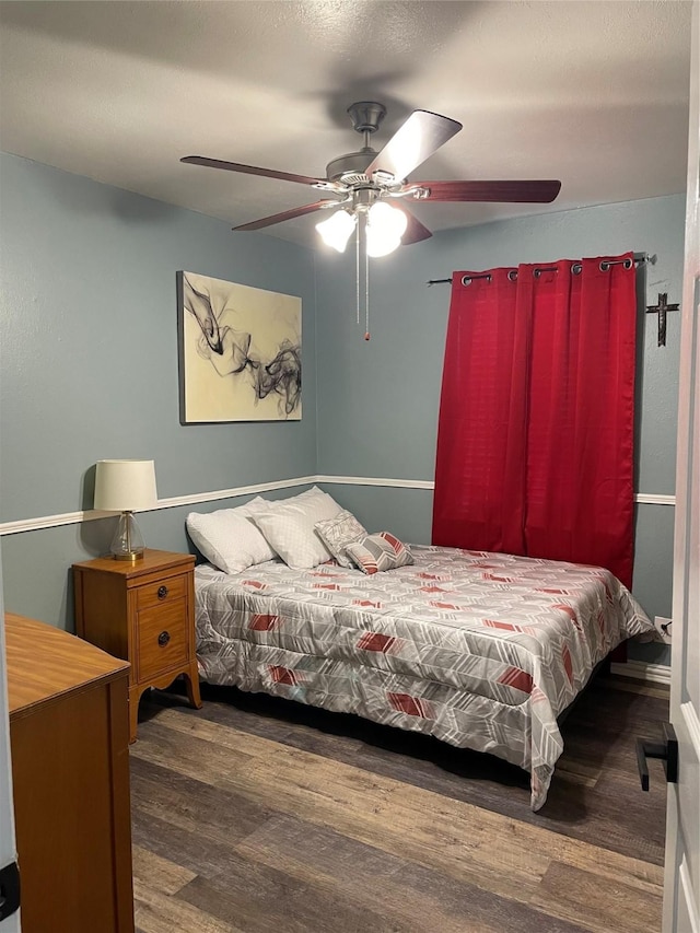 bedroom with a ceiling fan and wood finished floors