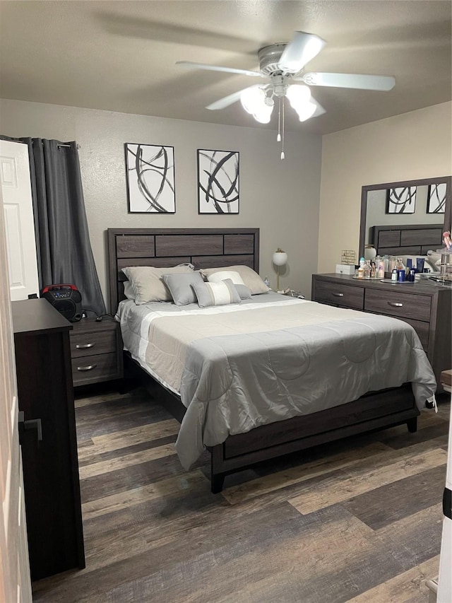 bedroom featuring dark wood-style floors and a ceiling fan