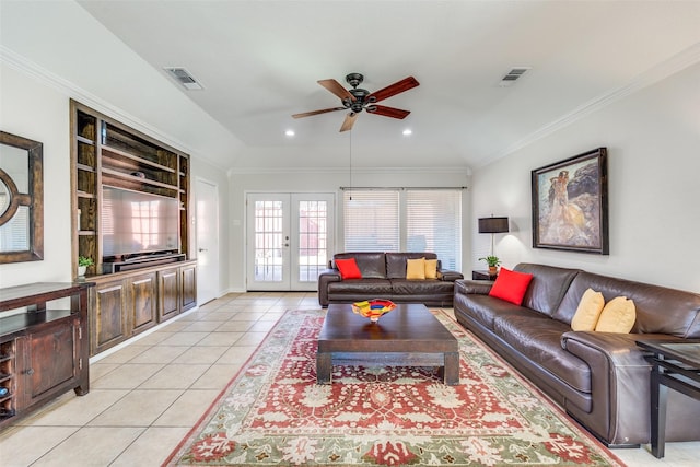 living room with french doors, visible vents, light tile patterned flooring, and crown molding