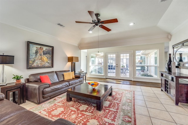 living room featuring visible vents, french doors, crown molding, light tile patterned floors, and vaulted ceiling