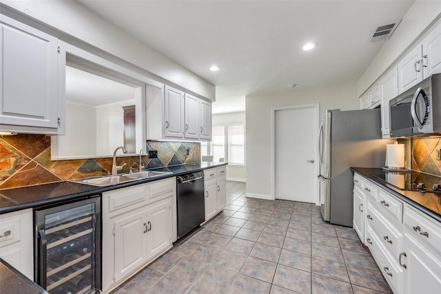 kitchen featuring dark countertops, wine cooler, white cabinets, black appliances, and a sink