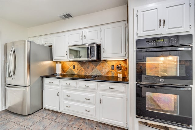 kitchen with visible vents, black appliances, backsplash, dark countertops, and white cabinets