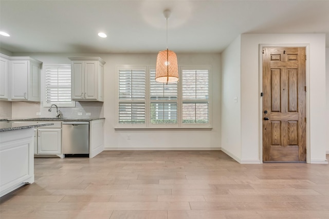 kitchen featuring dishwasher, light wood-style flooring, and a wealth of natural light