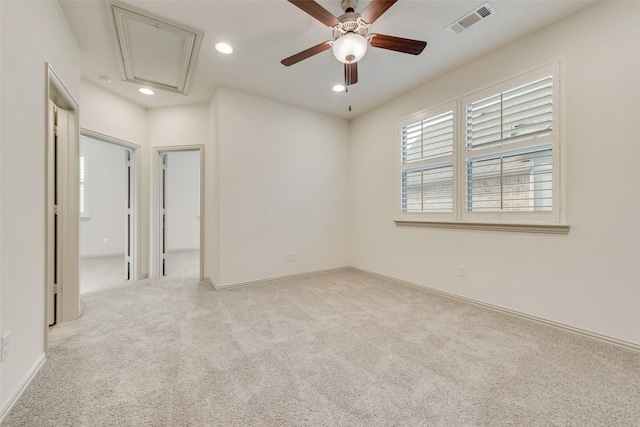 carpeted empty room with visible vents, recessed lighting, baseboards, attic access, and ceiling fan