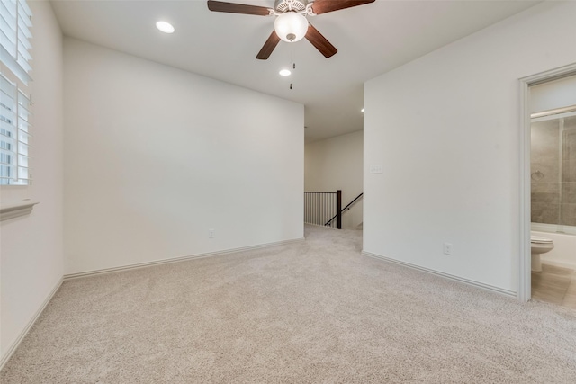 carpeted spare room with recessed lighting, a ceiling fan, and baseboards