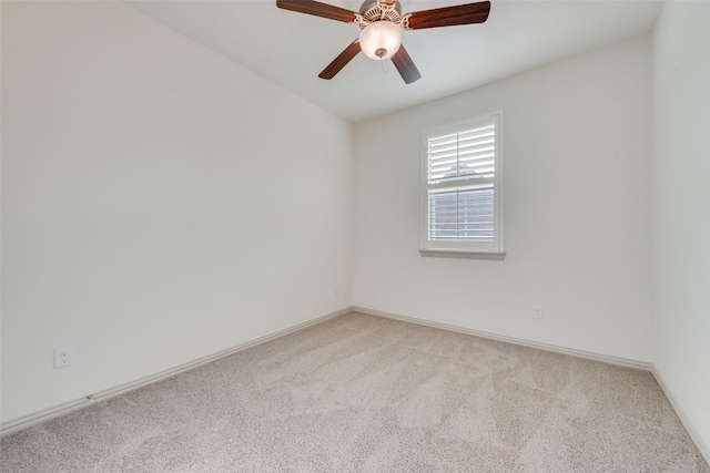 empty room featuring light carpet, baseboards, and ceiling fan