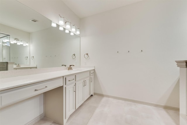 full bath featuring visible vents, vanity, and baseboards