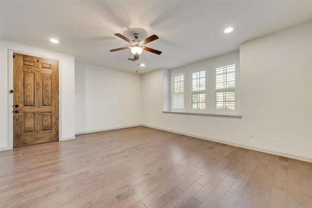 spare room featuring recessed lighting, baseboards, and light wood-style floors