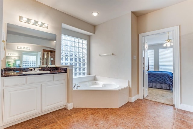 full bath featuring vanity, a bath, tile patterned flooring, and ensuite bathroom