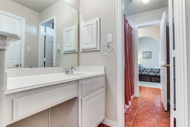 full bathroom featuring baseboards, vanity, and tile patterned flooring