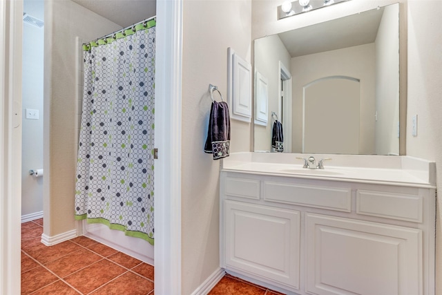 bathroom featuring tile patterned flooring, visible vents, vanity, and baseboards