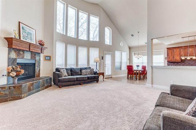 living room featuring carpet flooring, a healthy amount of sunlight, a fireplace, and baseboards