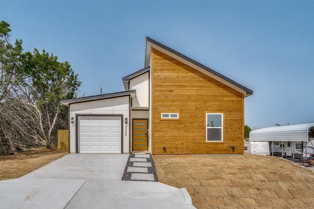 modern home featuring concrete driveway and a garage