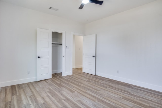 unfurnished bedroom featuring baseboards, visible vents, light wood finished floors, and ceiling fan