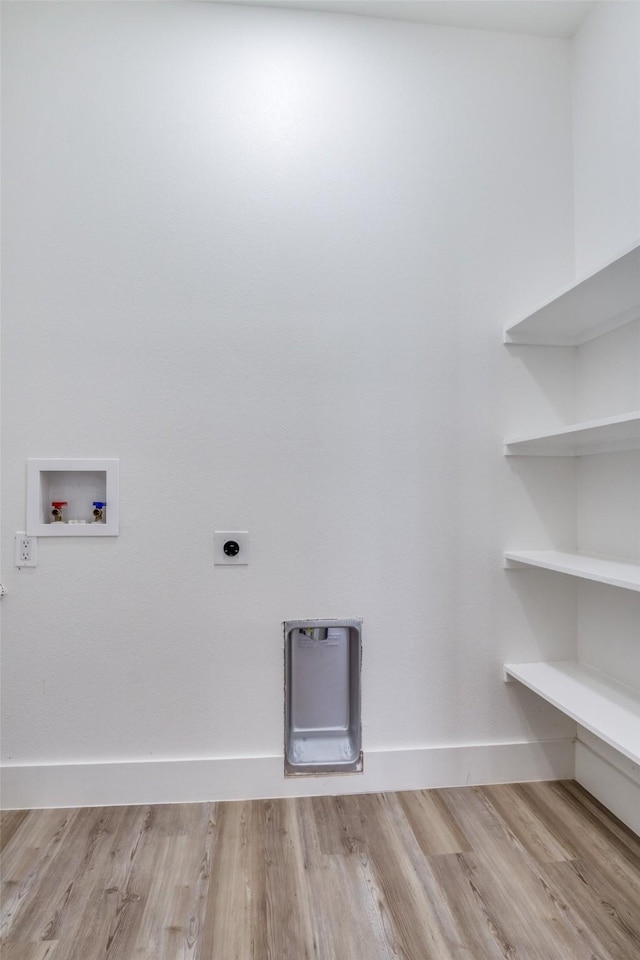 clothes washing area featuring baseboards, laundry area, light wood-style flooring, electric dryer hookup, and washer hookup