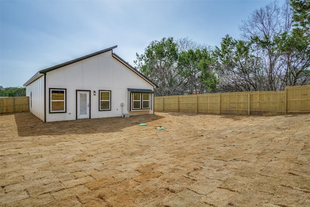 back of house with a fenced backyard