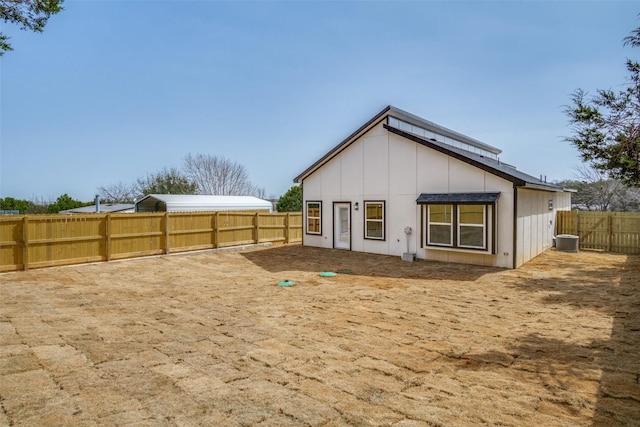 back of house with a fenced backyard