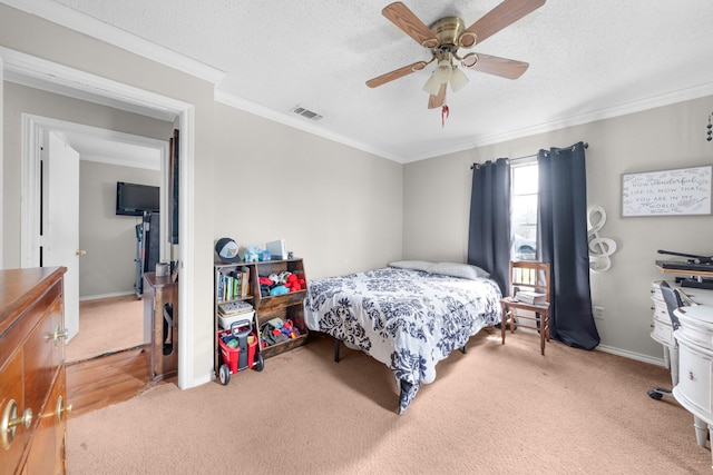 bedroom with visible vents, crown molding, baseboards, light colored carpet, and a textured ceiling