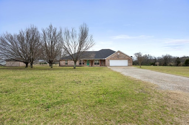 ranch-style home with a front yard, an attached garage, brick siding, and driveway