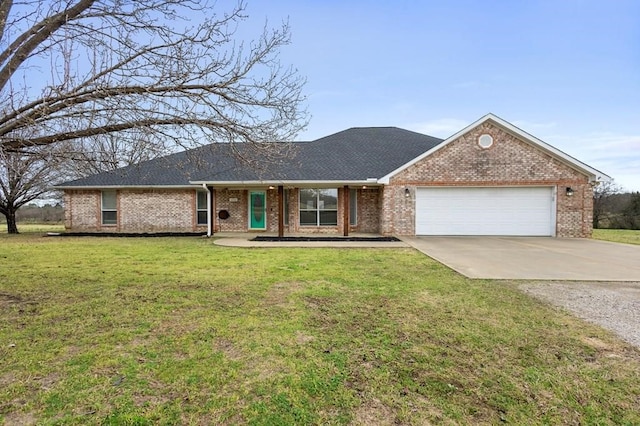 single story home featuring a front lawn, an attached garage, brick siding, and driveway