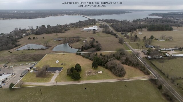 drone / aerial view with a water view and a rural view