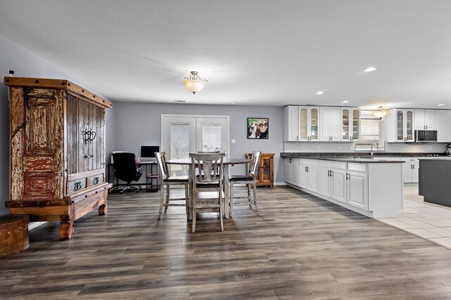 dining space with a wealth of natural light, recessed lighting, and dark wood-type flooring