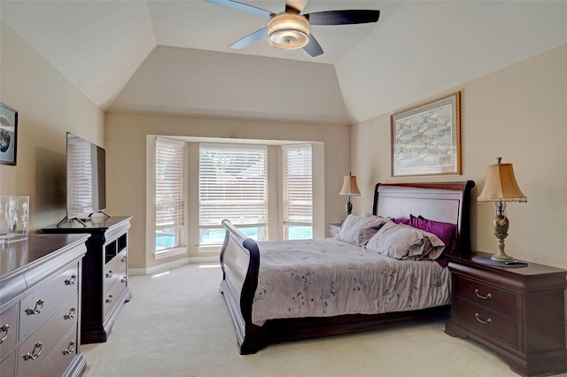 bedroom featuring light colored carpet, baseboards, lofted ceiling, and ceiling fan