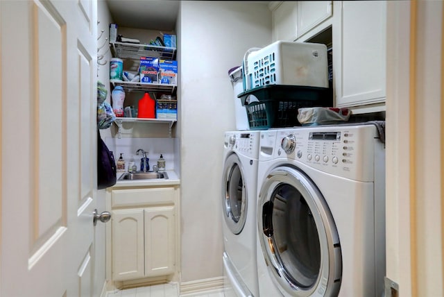 laundry room featuring cabinet space, washer and dryer, and a sink