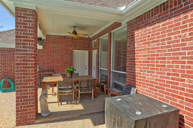 view of patio with outdoor dining area and a ceiling fan